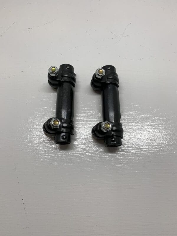 A pair of black metal handles with two small bolts.