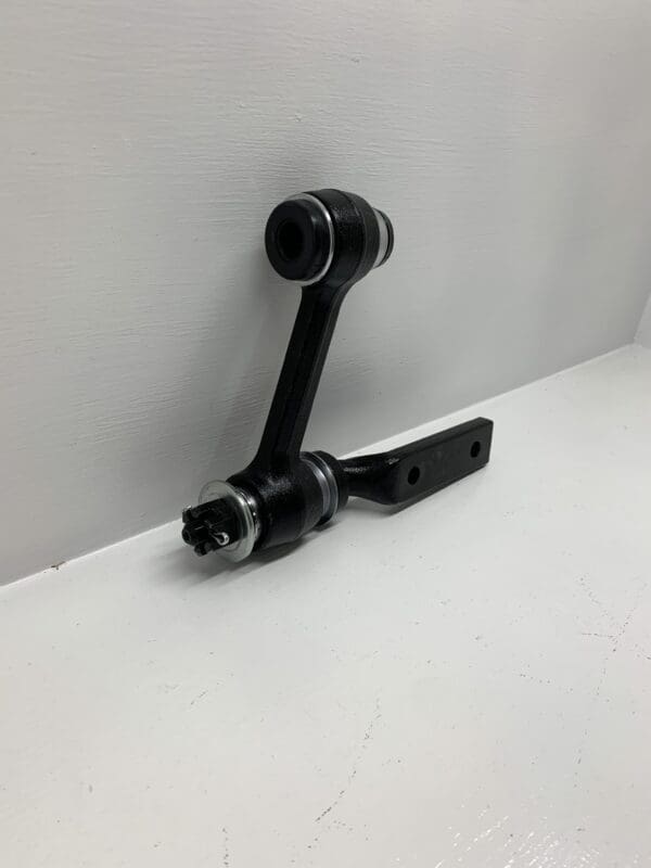 A black handle and arm on the wall