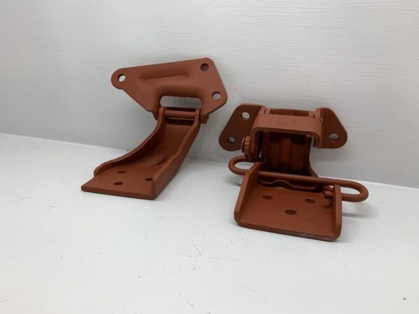 A pair of brown plastic brackets on top of a table.