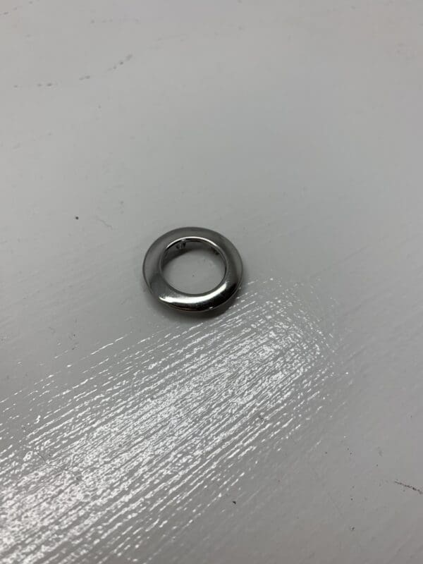 A metal ring sitting on top of a white table.